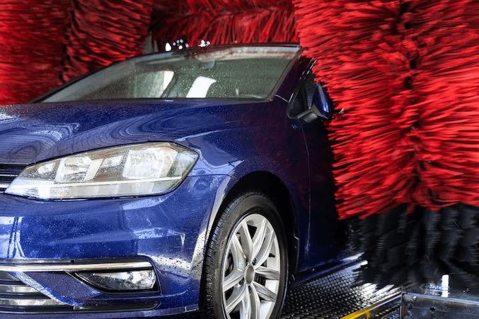 Blue car getting washed
