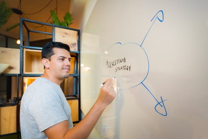 Man writing on white board